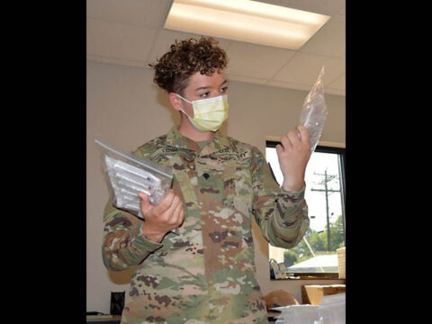 Spc. Megan Losh, a military police officer with Cleveland’s 252nd Military Police Company, reviews COVID-19 vaccination supplies for a mobile vaccination event in Jasper. Losh joined the Tennessee National Guard’s COVID-19 task force in February 2021. (Sgt. Finis L. Dailey, III)