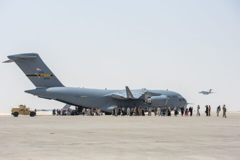 Evacuees from Afghanistan disembark a C-17 Globemaster lll, August 23rd, at Al Udeid Air Base, Qatar. (Air Force Airman 1st Class Kylie Barrow)