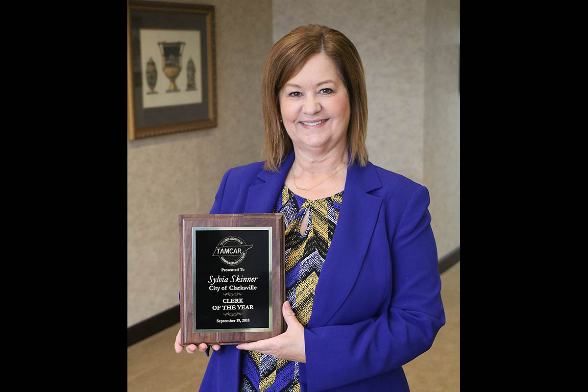 Sylvia Skinner proudly displays her 2018 Clerk of the Year plaque, bestowed by the Tennessee Association of Municipal Clerks & Recorders.