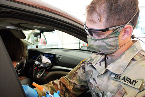 Sgt. Joseph Brummett, a combat medic with Henderson’s Headquarters and Headquarters Troop, 1st Squadron, 278th Armored Cavalry Regiment, prepares to administer a COVID-19 vaccination in Jasper on June 15th. Brummett has participated in the Tennessee National Guard’s COVID-19 Task Force since April 2020. (Sgt. Finis L. Dailey, III)