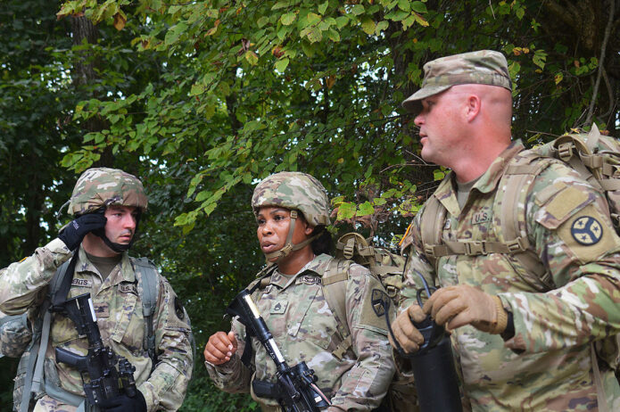 Sgt. Jonathan Roberts (left), and Staff Sgt. Tamecca Johnson (center), students of the First Line Leadership Course pilot, discuss tactical squad movements with instructor Sgt. First Class Brandon Kolesar (right), in Smyrna on Sept. 15. The course participants built a terrain model, conducted a tactical squad movement and practiced medical evacuation procedures. (Sgt. Finis L. Dailey, III) 