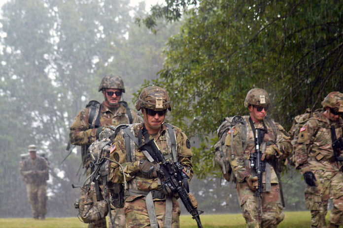 Soldiers with the Tennessee Army National Guard conduct a squad movement in the rain during the First Line Leadership Course pilot in Smyrna on Sept. 15. Soldiers were instructed on constructing a terrain model using a map, planning a movement route, and how to adjust their squad’s formation based on the terrain. (Sgt. Finis L. Dailey, III)