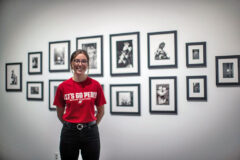 Austin Peay State University sudent Katie Boyer in front of some of the photos she worked with. (APSU)