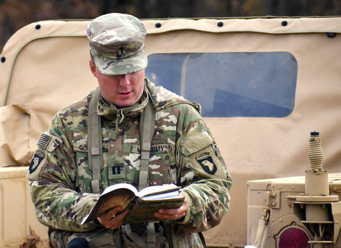 Chaplain (Capt.) Roger E. Gordon, 101st Special Troops Battalion, 101st Division Sustainment Brigade, reads a scripture during a worship service on Fort Campbell, KY, November 19th, 2021. (Sgt. Amal Hall, 101st Division Sustainment Brigade Public Affairs)