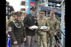 Blanchfield Army Community Hospital command team, Col. Vincent B. Myers and Command Sgt. Maj. Daniel Santiago, and 101st Combat Aviation Brigade Commander Col. Travis M. Habhab and Chief Warrant Officer 5 Steve Dermer, 101st CAB command chief warrant officer, accept a commemorative game ball on behalf of their Soldiers who participated in pregame ceremonies before the NFL’s Tennessee Titans and New Orleans Saints football game at Nissan Stadium, Nov. 14. Soldiers from Blanchfield Army Community Hospital, Soldier Recovery Unit, Dental Activity, Public Health Activity and 531st Hospital Center unfurled a U.S. flag and served as the honor guard during the national anthem.  (U.S. Army photo by Maria Yager)