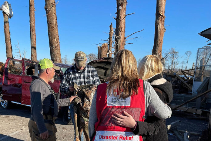 American Red Cross volunteer Connie Hopper comforts families as rescue and recovery continues in Cypress Point, Lake County, Tennessee. (John Brown, American Red Cross)