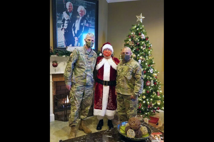 Blanchfield Army Community Hospital Command Team, Col. Vincent B. Myers and Command Sgt. Maj. Daniel Santiago, met Santa Claus at the Fort Campbell Fisher House recently. The Fisher House provides military families no cost temporary housing close to a loved one in the hospital for an illness, disease or injury. (Maria Christina Yager, Blanchfield Army Community Hospital)