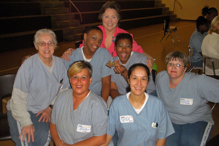 Linda Lee White (top), founder and executive director of Women Ablaze Ministries, with members of the prison ministry.