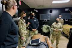 Regional Health Command-Atlantic Command Team, Brig. Gen. Mary V. Krueger (left) and Command Sgt. Maj. Rebecca Booker (right) speak with Soldiers from the Rascon School of Combat Medicine on Fort Campbell, Kentucky Jan. 11. The Rascon Soldiers demonstrated capabilities of medical training simulators used at the center to teach combat medic specialists and other Soldiers evidence-based, life-saving techniques and strategies for providing the best trauma care on the battlefield. (Maria Christina Yager, Blanchfield Army Community Hospital)