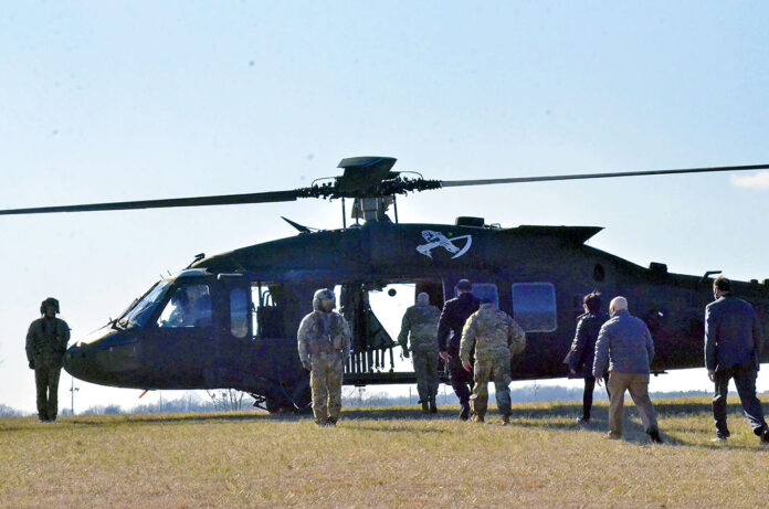 U.S. Army Garrison-Fort Campbell’s leadership team boards a helicopter Feb. 7 at The Sabalauski Air Assault School alongside Installation Services Director Michael E. Reheuser, Office of the Deputy Chief of Staff, G-9, Headquarters, to provide an aerial view of the installation’s training areas and ranges. (Ethan Steinquest, Fort Campbell Public Affairs Office)