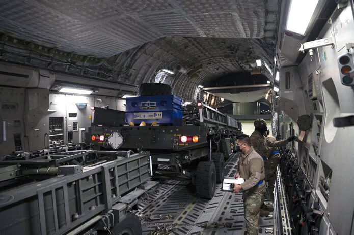 Airmen load cargo for delivery to Ukraine onto a C-17 Globemaster III at Travis Air Force Base, CA, February 14th, 2022. (Air Force Senior Airman Karla Parra)