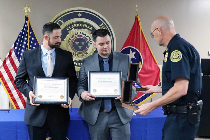 Clarksville Police Chief David Crockarell (far right) presents Officers Daniel Smith (left) and David Hauser (right) with the Lifesaving Award.