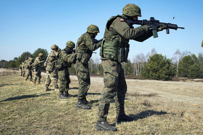 Paratroopers assigned to 3rd Brigade Combat Team, 82nd Airborne Division, and Polish soldiers assigned to the 18th Mechanized Division, engage targets during a combined live-fire training event in Nowa Deba, Poland, March 15th, 2022. The 82nd Airborne Division is currently deployed to Poland at the invitation of Polish allies to enhance readiness and strengthen the NATO alliance. (Army Sgt. Claudia Nix)