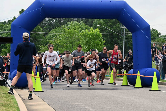 Participants of the 2021 Queen City Road Race begin the 10K run.