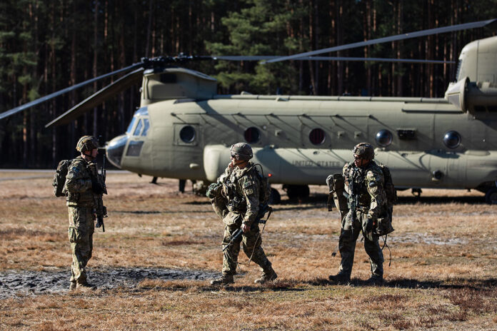 U.S. paratroopers assigned to the 3rd Brigade Combat Team, 82nd Airborne Division arrive in Nowa Deba, Poland during a combined training event, Feb. 24, 2022.