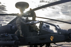 U.S. soldiers assigned to Alpha Troop “Nightmare”, 7th Squadron, 17th Cavalry Regiment, 1st Air Cav. Brigade, 1st Cav. Division conduct pre-flight inspections on an AH-64D Apache before departing from Storck Barracks, Illesheim, Germany, Feb. 24, 2022, en route to Poland.