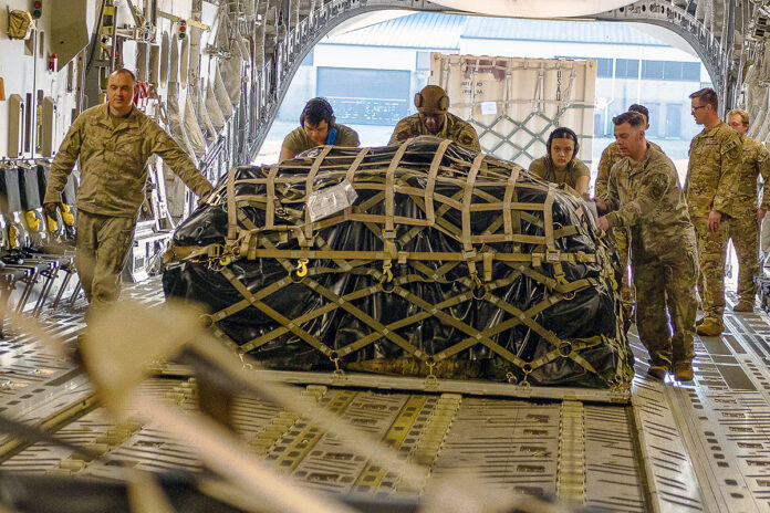 Air Force airmen load cargo on a C-17 bound for Poland at Pope Army Airfield, NC, February 10th, 2022. (James Bove, Air Force)