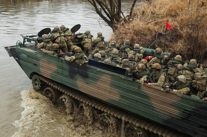 U.S. paratroopers from 1st Battalion, 508th Parachute Infantry Regiment, 3rd Brigade Combat Team, 82nd Airborne Division, cross a river in a Polish amphibious craft during combined training exercises near Zamosc, Poland, March 31st, 2022.