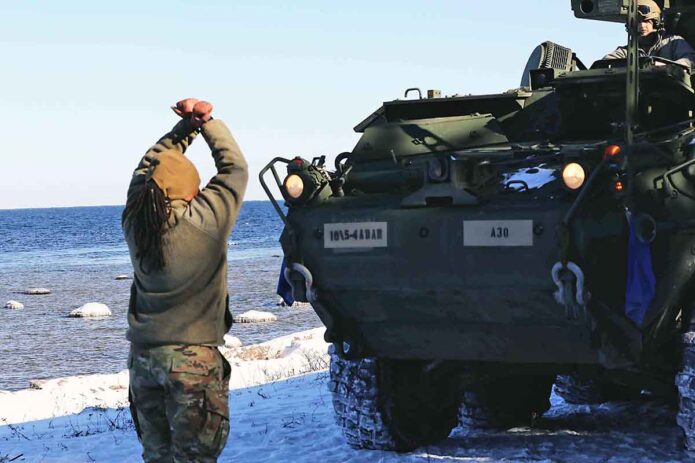  U.S. Army Staff Sgt. Tiana Trent, an avenger master gunner in the 5th Battalion 4th Air Defense Artillery Defense Regiment, halts the Stryker in position for staging, March 9, 2022, near Rutja, Estonia. (Army National Guard Sgt. Ryan S. Gay)