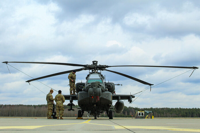 Soldiers assigned to 1st Air Cavalry Brigade, 1st Cavalry Division conduct daily preventive maintenance on an AH-64E Apache Guardian attack helicopter at a forward arming and refueling point, Miroslawiec, Poland, April 4th, 2022. (Army Spc. Hedil Hernández, National Guard)