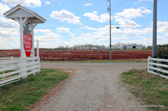 Entrance to the McCraw Strawberry Ranch with an empty field across the street.
