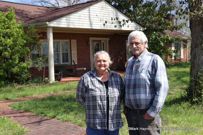 Billy and Teresa McCraw standing in front of their home that is threatened by the Rossview Road Widening Project.