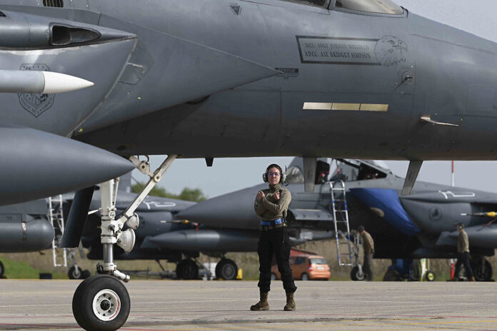 A U.S. Air Force airman assigned to the 492nd Fighter Squadron from Royal Air Force Lakenheath, England, prepares an F-15E Strike Eagle for takeoff at Andravida Air Base, Greece, April 5, 2022. The U.S., Cyprus, France, Israel, Romania, Italy, Slovenia, Austria and Canada supported and participated in INIOCHOS 22, an operational and tactical level training exercise hosted by the Hellenic Air Tactics Center at Greece’s fighter weapons school. (Air Force Staff Sgt. Malissa Lott)