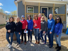 The Legends Bank team poses in front of ‘The House that Legends Built’ on Richardson Street in Clarksville.