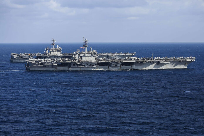 The USS Carl Vinson and USS Abraham Lincoln transit the Philippine Sea, January 22nd, 2022. Operating as part of U.S. Pacific Fleet, units assigned to Carl Vinson and Abraham Lincoln Strike Groups, Essex and America Amphibious Ready Groups, alongside Japan Maritime Self-Defense Force, are conducting training to preserve and protect a free and open Indo-Pacific region. (Navy Petty Officer 3rd Class Thaddeus Berry)