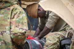 Spc. Maruh Massaquoi, a wheeled vehicle mechanic with E Forward Support Company, 21st Brigade Engineer Battalion, 3rd Brigade Combat Team, 101st Airborne Division (Air Assault), works to repair a military vehicle during the Division Training Density. (U.S. Army photo by Staff Sgt. Michael Eaddy)