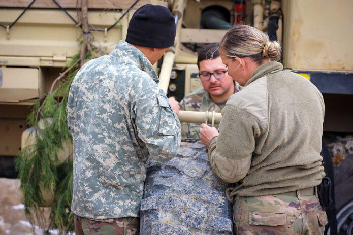 Soldiers with E Forward Support Company, 21st Brigade Engineer Battalion, 3rd Brigade Combat Team, 101st Airborne Division (Air Assault) work together to repair a military vehicle during the Division Training Density. (U.S. Army photo by Staff Sgt. Michael Eaddy)