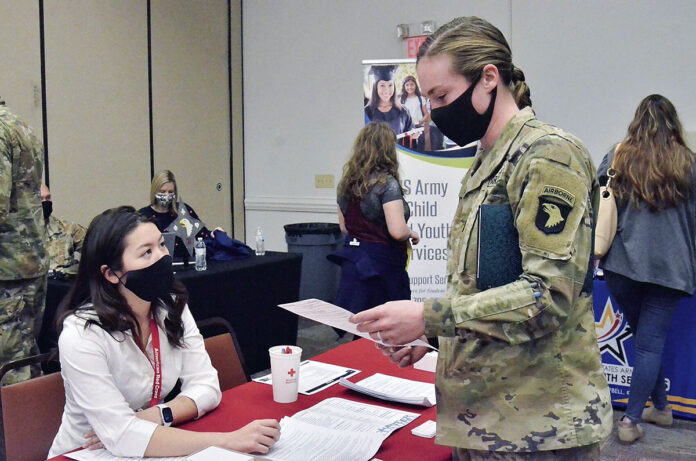 First Lieutenant Caneel Cooper, 2nd Squadron, 17th Cavalry Regiment, 101st Combat Aviation Brigade, 101st Airborne Division (Air Assault), talks to American Red Cross volunteer Serena Vess about the organization’s services March 2nd during a deployment readiness at Army Community Service. (Ethan Steinquest, Fort Campbell Courier)