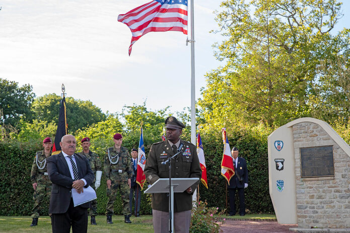 Col. Mark A. Denton, commander of the 207th Military Intelligence Brigade (Theater), speaks at a ceremony remembering the fallen paratroopers from the 101st Airborne Division in Beuzeville au Plain, France, June 1, 2022. During D Day operations a C47 carrying 17 paratroopers was hit by anti-aircraft fire and crash landed, killing 5 crew and the paratroopers. (Staff Sgt. Alexander Skripnichuk, U.S. Army) 