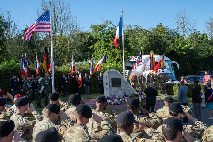 U.S. Army Soldiers with the 101st Airborne Division salute the U.S. Flag during a ceremony to honor paratroopers who died in an airplane crash during D Day operations in Beuzeville au Plain, France, June 1, 2022. During D Day operations a C47 carrying 17 paratroopers was hit by anti-aircraft fire and crash landed, killing 5 crew and the paratroopers. (Staff Sgt. Alexander Skripnichuk, U.S. Army) 