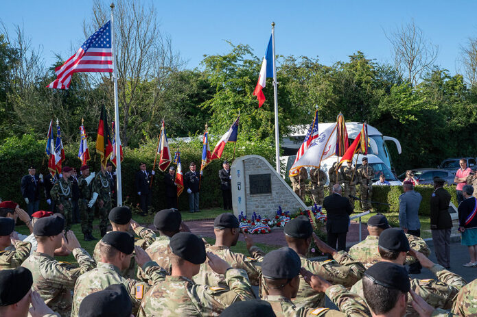 U.S. Army Soldiers with the 101st Airborne Division salute the U.S. Flag during a ceremony to honor paratroopers who died in an airplane crash during D Day operations in Beuzeville au Plain, France, June 1, 2022. During D Day operations a C47 carrying 17 paratroopers was hit by anti-aircraft fire and crash landed, killing 5 crew and the paratroopers. (Staff Sgt. Alexander Skripnichuk, U.S. Army)