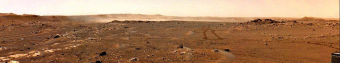 This image from a navigation camera aboard NASA’s Perseverance rover shows a gust of wind sweeping dust across the Martian plain beyond the rover’s tracks on June 18th, 2021 (the 117th sol, or Martian day, of the mission). The dust cloud in this photo was estimated to be 1.5 square miles (4 square kilometers) in size; it was the first such Martian wind-lifted dust cloud of this scale ever captured in image. (NASA/JPL-Caltech/SSI)