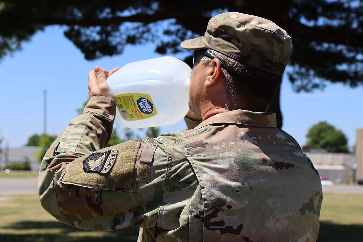 Sergeant First Class Jacab Cooper, 101st Airborne Division (Air Assault), drinks water to combat the heat June 24. Nita Hackwell preventative medicine and environmental health at Blanchfield Army Community Hospital, or BACH, said residents can avoid heat injury by knowing what to expect outside. “The heat line provides the wet bulb globe temperature, or WBGT, index and heat category to members of the Fort Campbell community training, working, and playing outdoors in direct sunlight,” she said. “Monitoring the WBGT index is an important step in determining when modifications to outdoor physical activity should be made to prevent heat-related illnesses.” (Sirena Clark)