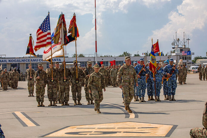 U.S. Soldiers with the 101st Airborne Division (Air Assault) march in formation led by Maj. Gen. JP McGee, commanding general, 101st Airborne Division (Air Assault), and Command Sgt. Maj. Veronica Knapp, command sergeant major, 101st Airborne Division (Air Assault), during an uncasing ceremony at Mihail Kog?lniceanu Air Base, Romania, July 30, 2022. The 101st Airborne Division is deployed as part of V Corps, America’s Forward Deployed Corps in Europe, which works alongside NATO Allies and regional security partners to provide combat-ready forces, execute joint and multinational training exercises, and retain command and control for all rotational and in the European theater. (Spc. Elizabeth MacPherson) 