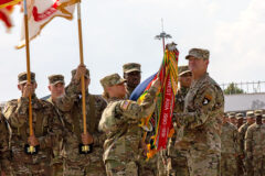 U.S. Army Maj. Gen. JP McGee, right, commanding general, 101st Airborne Division (Air Assault), and Command Sgt. Maj. Veronica Knapp, left, uncase the division colors during a ceremony at Mihail Kog?lniceanu Air Base, Romania, July 30, 2022. The ceremony officially marked the arrival of the Screaming Eagles to the European theater in support of V Corps, America’s Forward Deployed Corps, who oversee all rotational forces in Europe. (Spc. Elizabeth MacPherson)
