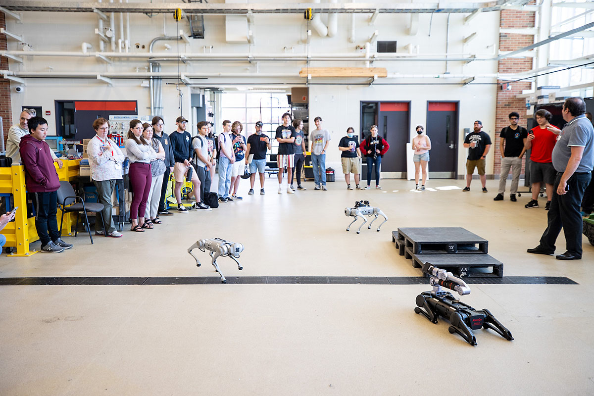 Austin Peay State University students and employees watch as Unitree quadruped robots venture around the room. (APSU)