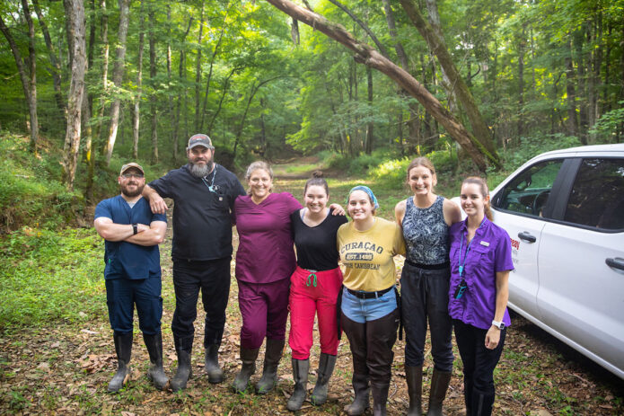 Haase, third from left, poses with her team before setting up for the night. (APSU)