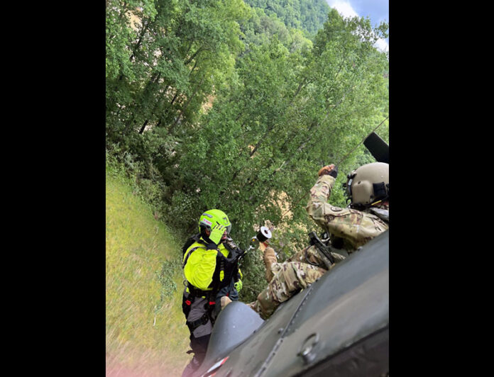 A crewmember is lowered from a Blackhawk helicopter to rescue a flood victim in Eastern Kentucky. (Tennessee National Guard)