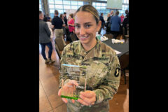 Blanchfield Army Community Hospital’s former Partner in Education coordinator, Sgt. 1st Class Jamie Hendzel, displays the 2022 Partners in Education Boots on the Ground Award at the annual Clarksville-Montgomery County Education Foundation and Clarksville Area Chamber of Commerce Partners in Education Appreciation Breakfast in Clarksville, Tennessee, Aug. 30. Hendzel recently transferred to a line unit with 101st Airborne Division’s 2nd Brigade Combat Team, but was able to attend the breakfast and join BACH’s new PIE coordinator, Staff Sgt. Sierra Brown, in accepting the award. (Maria Yager)