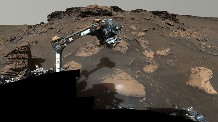 NASA’s Perseverance rover puts its robotic arm to work around a rocky outcrop called “Skinner Ridge” in Mars’ Jezero Crater. Composed of multiple images, this mosaic shows layered sedimentary rocks in the face of a cliff in the delta, as well as one of the locations where the rover abraded a circular patch to analyze a rock’s composition. (NASA/JPL-Caltech/ASU/MSSS)