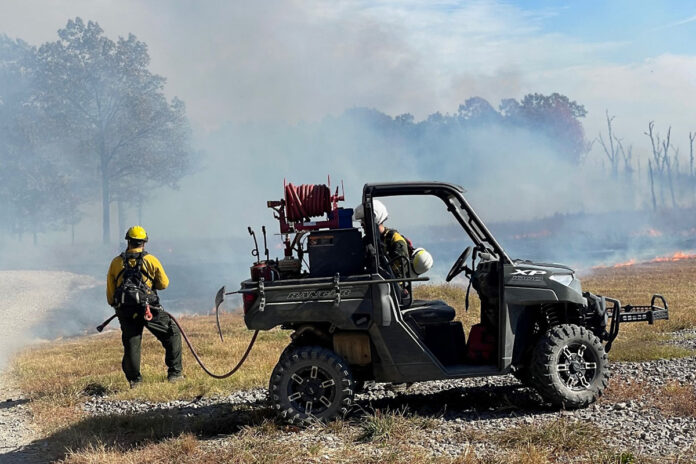 Fort Campbell personnel using burn control techniques to manage the fire that occurred in a training area Friday.