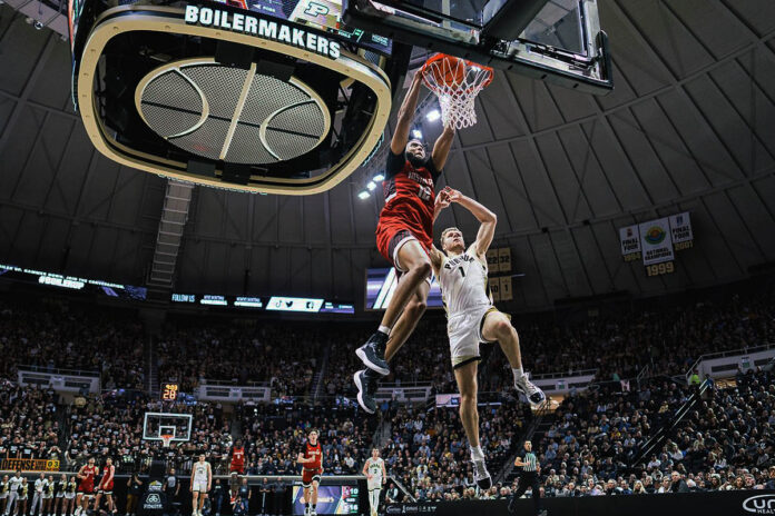 Austin Peay State University Men's Basketball forward Shon Robinson explodes past Purdue's Caleb Furst for a two-handed dunk in the first half Friday. (APSU Sports Information)