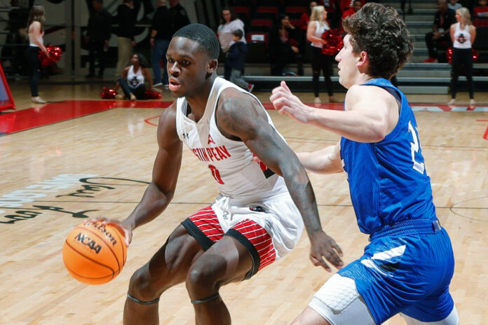 Austin Peay State University's Sean Durugordon drives on Lindsey Wilson's Connor Robinson in the first half Monday. (Robert Smith, APSU Sports Information)