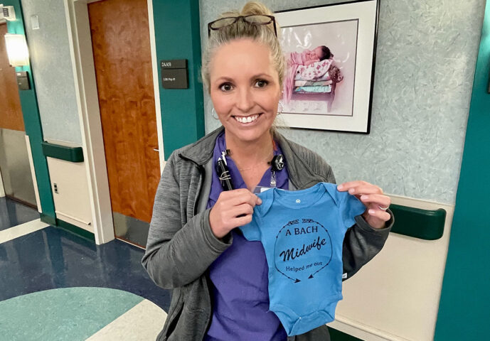Blanchfield Army Community Hospital Certified Nurse Midwife Jessica Chance gives a special onesie to each baby she helps deliver on Fort Campbell. A certified nurse midwife is an advanced practice nurse specially trained to provide prenatal care, deliver babies and provide postpartum care for patients with low-risk pregnancies. (Maria Yager, Department of Defense)