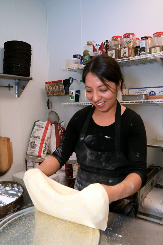 Claudia Amaya preparing a home-made crust that will be the base of a Camacho’s Famous pizza. (Tony Centonze, Clarksville Online)