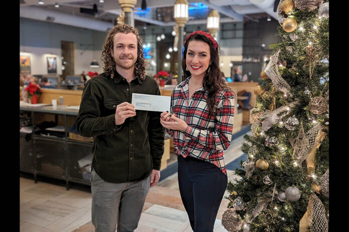 Erin Yow and Wes Cunningham with The Mailroom’s donation.